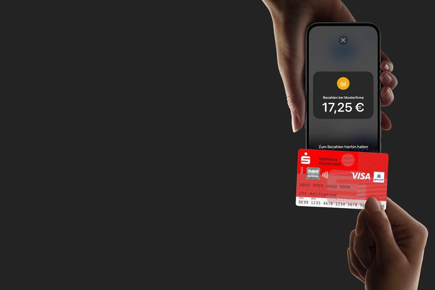 Eine Sparkassen-Card wird an ein iPhone gehalten, der Hintergrund ist schwarz